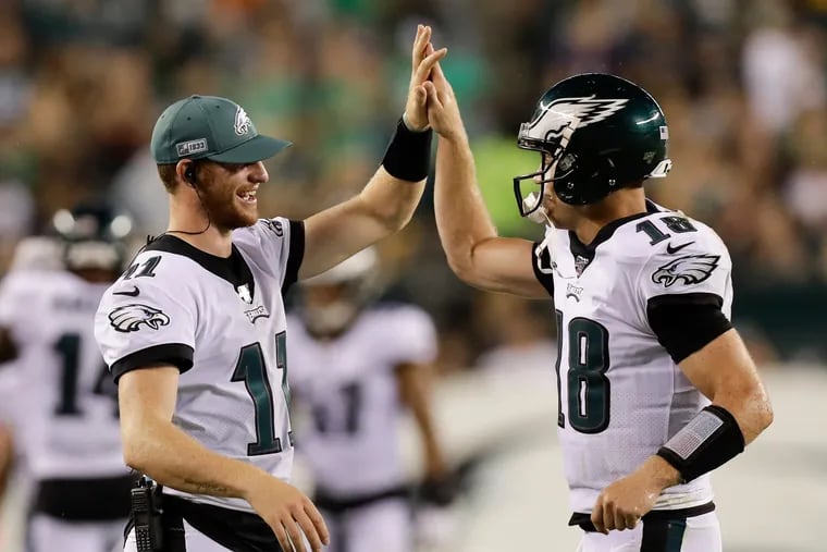 Eagles quarterback Josh McCown (right) celebrated a third-quarter two-point conversion with teammate Carson Wentz against the Ravens last Thursday.