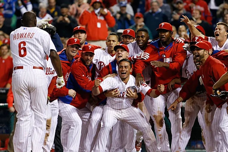 Phillies players celebrate and wait for Ryan Howard, left, to cross home plate after Howard's game-winning three-run home run off Colorado Rockies relief pitcher Boone Logan during the ninth inning of a baseball game, Wednesday, May 28, 2014, in Philadelphia. Philadelphia won 6-3. (Matt Slocum/AP)