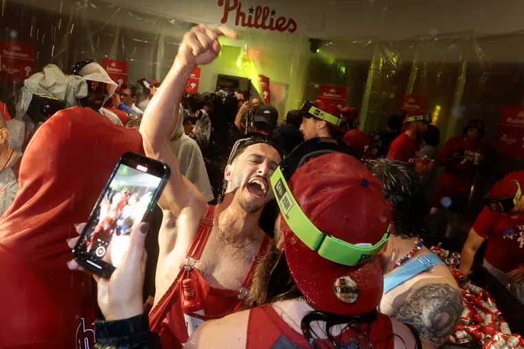 Catcher Garrett Stubbs celebrates with his Phillies teammates in the locker room after the wild-card sweep of the Miami Marlins was complete.
