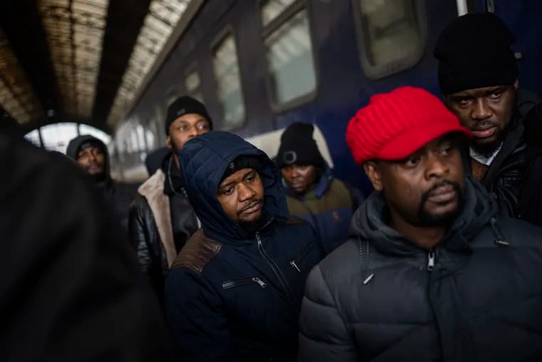 African residents in Ukraine wait at the platform inside Lviv railway station, Sunday, Feb. 27, 2022, in Lviv, west Ukraine. Thousands of people massed at Lviv's main train station on Sunday, attempting to board trains that would take them out of Ukraine and into the safety of Europe as the Russian invasion of that country continued.