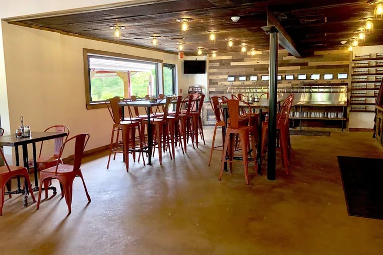 A dining room with beer wall at the rear at Vince's Pizzeria in Wrightstown Township.