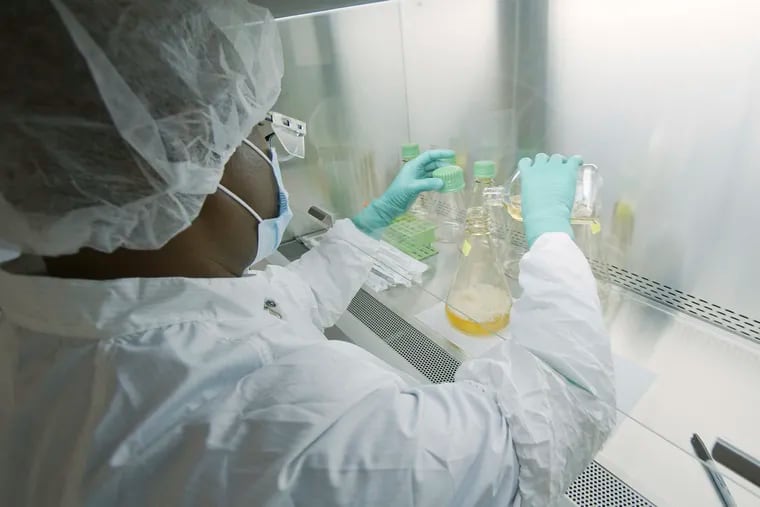 In this May 2020 photo provided by Eli Lilly, a researcher tests possible COVID-19 antibodies in a laboratory in Indianapolis. Antibodies are proteins the body makes when an infection occurs; they attach to a virus and help it be eliminated.