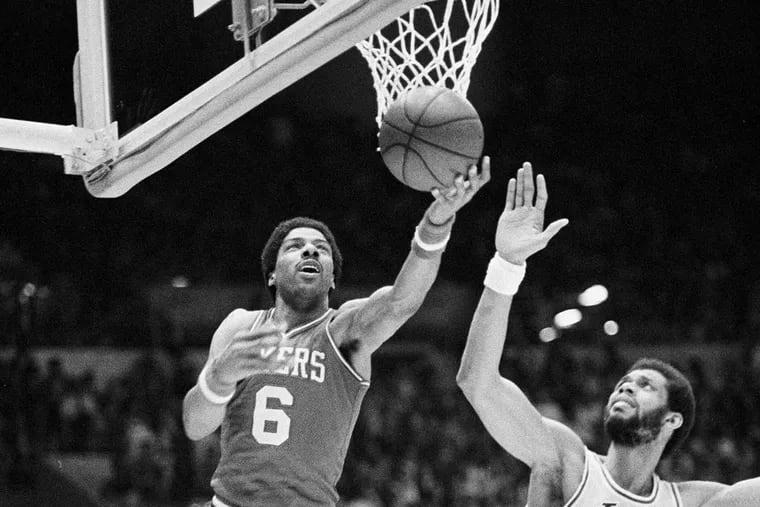 Philadelphia 76ers center Julius Erving (6) goes up and around the basket to score against Los Angeles Lakers center Kareem Abdul-Jabbar (33) during the NBA Championships in Los Angeles in 1980. AP / File