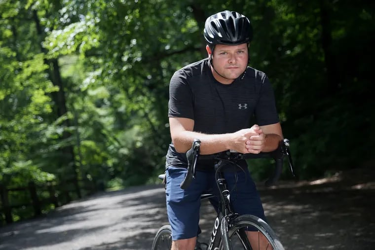 Former Philadelphia Police Department Officer Jesse Hartnett on his bike at Wissahickon Valley Park. Hartnett, who retired from the department after being shot in an ambush, is training for the Ben to the Shore bike ride from Philadelphia to Atlantic City, which raises money for the families of fallen first responders.