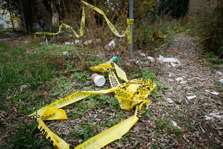 Philadelphia police crime scene tape at an empty lot along E. Cumberland St. at Jasper in Kensington where the body of a young woman was found over the weekend. (Alejandro A. Alvarez / Staff Photographer)