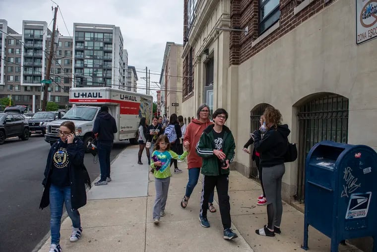 Students and parents gather outside John W. Hallahan Girls' High School in Philadelphia after taking the SAT test Saturday May 4. The Auditor General's office is pushing debate as to whether Pa. should replace its mandatory Keystone Exams with state-funded SAT or ACT testing.