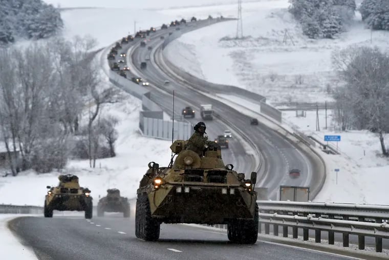 A convoy of Russian armored vehicles moves along a highway in Crimea, Tuesday, Jan. 18, 2022. Russia has concentrated an estimated 100,000 troops with tanks and other heavy weapons near Ukraine in what the West fears could be a prelude to an invasion.
