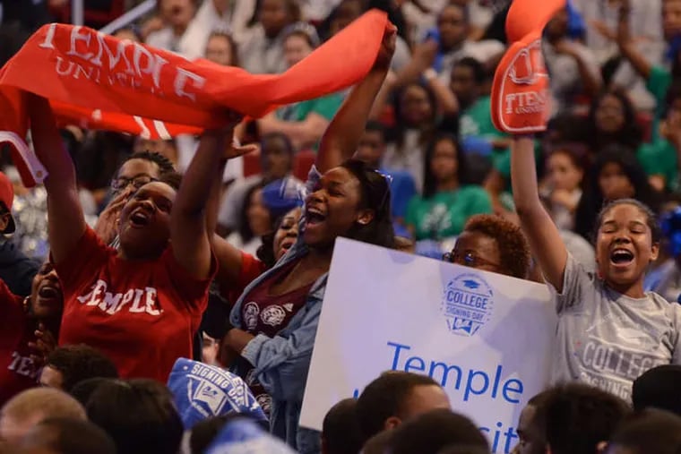 Students cheer during Mastery Charter School's College Signing Day ceremony in June.