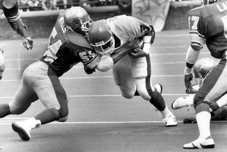 Sam Mills (left) tackles Herschel Walker in 1984.