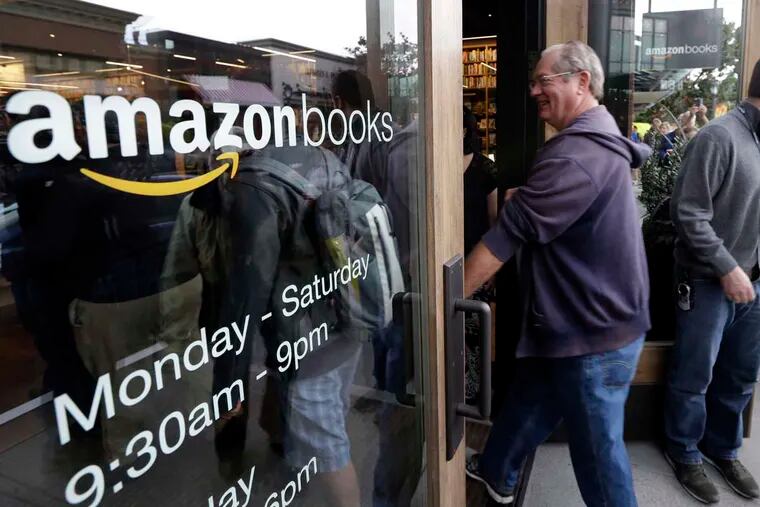 Customers enter on the opening day for Amazon Books, the first brick-and-mortar retail store for Amazon, in Seattle. The store opened Nov. 3.