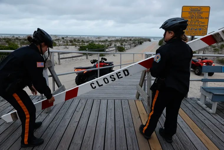 Ocean City police officers close off beach access during the 8 p.m. beach curfew last weekend.