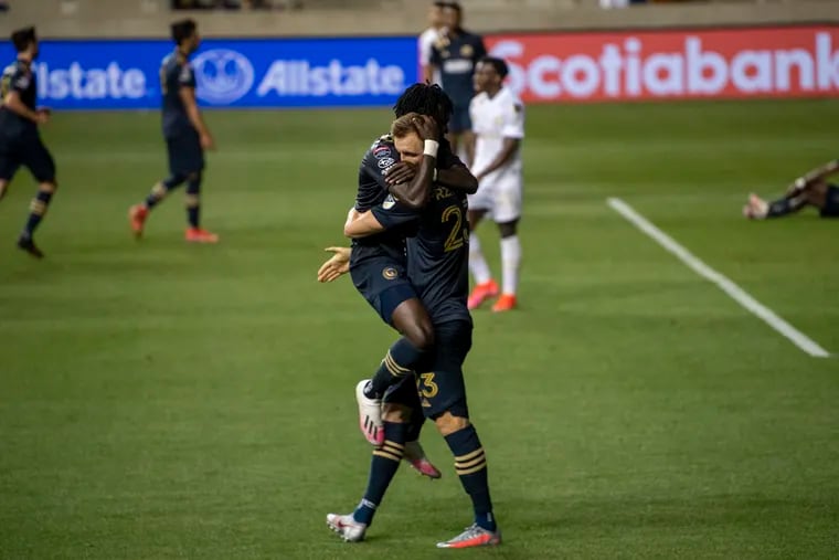 Kacper Przybylko (right) celebrates with Olivier Mbaizo after scoring the goal that finished the Union's Champions League series win over Atlanta United.