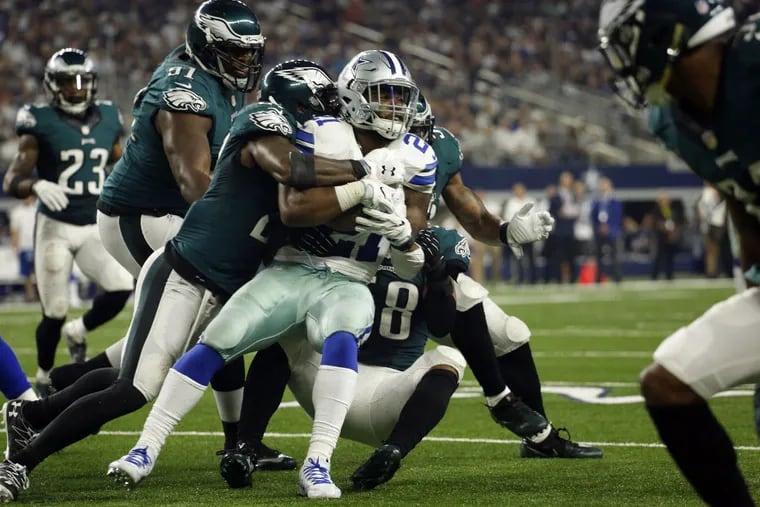 Cowboys running back Ezekiel Elliott (21) is wrapped up by Eagles strong safety Malcolm Jenkins (27) and others on Sunday, Oct. 30, 2016 at AT&amp;T Stadium in Arlington, Texas.