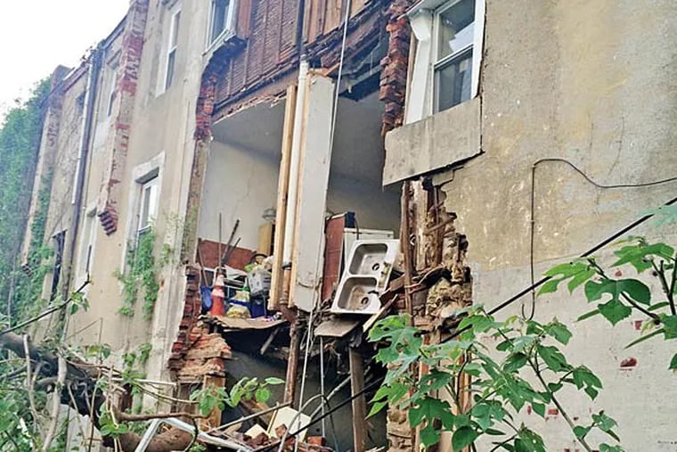 A family of five was displaced Sunday, May 11, 2014, when the back wall of a rowhouse on Glenmore Avenue collapsed. City inspectors responding to the collapse deemed 16 other buildings on the same street as unsafe or dangerous.