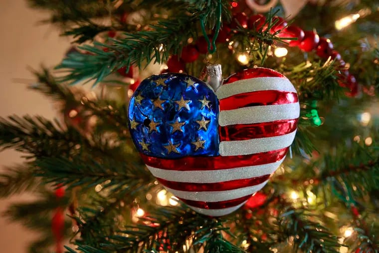The 9/11 ornament Brave Heart, designed by Christopher Radko, is the first one hung. DAVID SWANSON / Staff Photographer