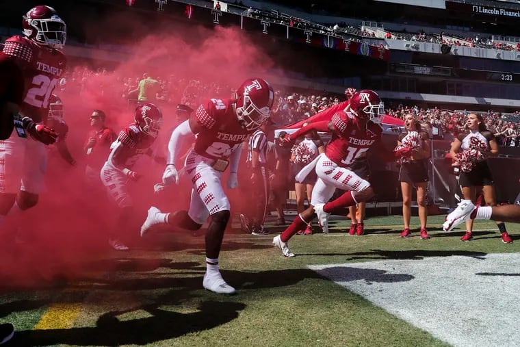 The Temple football team takes the field amid red smoke to face Wagner at Lincoln Financial Field last season.