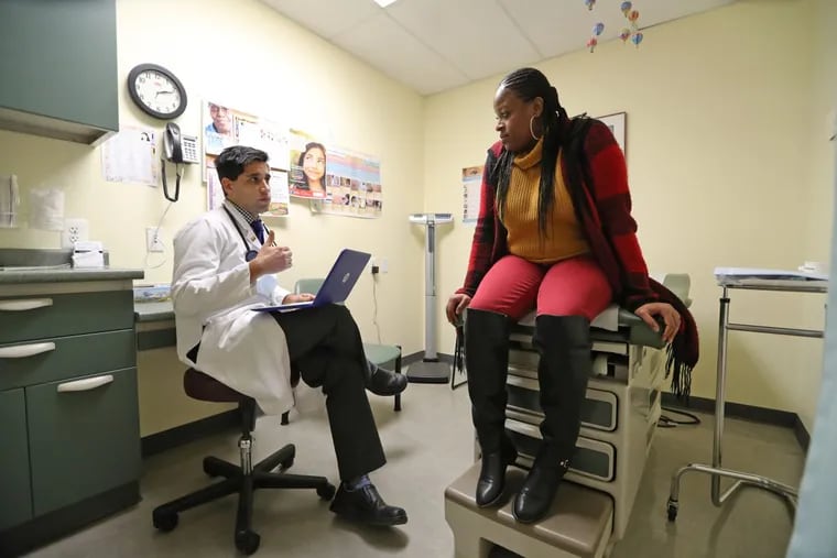 Tarik Khan speaks with a patient at Abbotsford Falls Family Practice in North Philadelphia, Friday December 6, 2016.