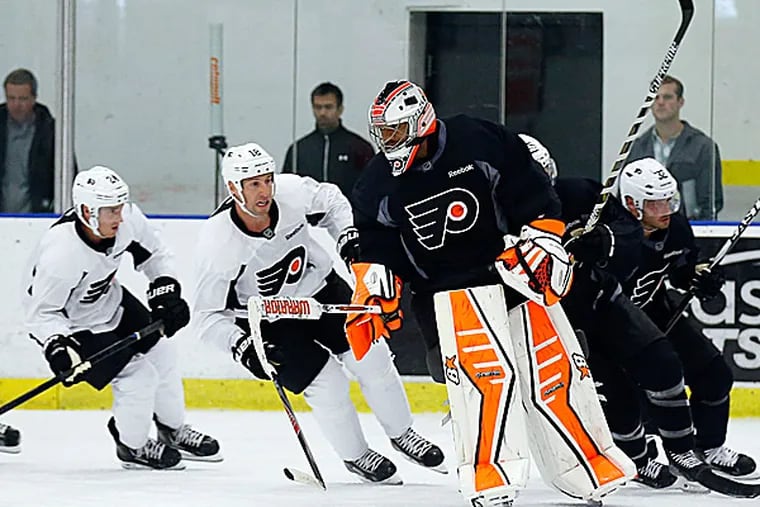 Flyers goalie Ray Emery and teammates warm up for practice. (Yong Kim/Staff Photographer)