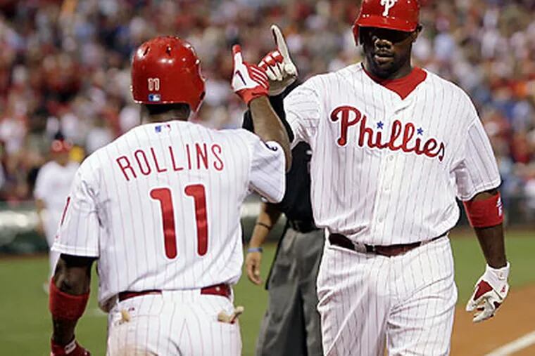 Ryan Howard celebrates his solo home run with Jimmy Rollins in Tuesday's win over the Marlins. (Yong Kim/Staff Photographer)