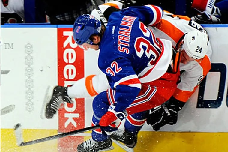 The Rangers' Anton Stralman checks Matt Read into the boards in the first period on Friday. (Henny Ray Abrams/AP)
