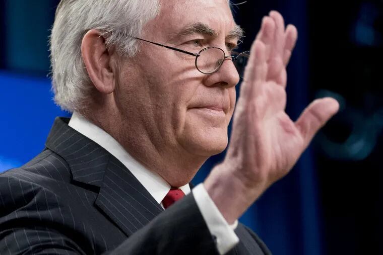 Secretary of State Rex Tillerson waves goodbye after speaking at a news conference at the State Department.