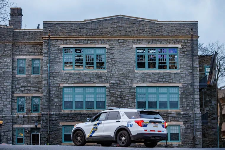 Philadelphia police keep watch over the Our Mother of Consolation Parish School, in the city's Chestnut Hill section, which was damaged in a Tuesday fire.