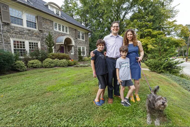 The Cukers — (from left)  Shalom, 12, Adam,  Lev, 9, and Amy, bought their 1929 stone home in Elkins Park in 2010 and have updated it for modern living.