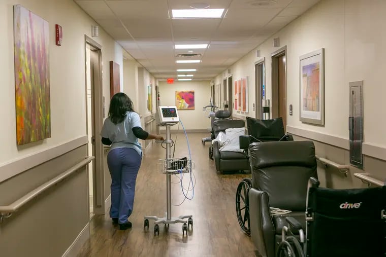An employee walks through the hallways of Tulip Special Care in Philadelphia in December 2019.