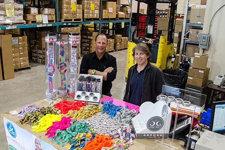 (L-R) Brett Pulli and Saul Denenberg owners of Slingshox, the maker of JoyJoy! watches in their warehouse in Souderton, Pa.. Elizabeth Wellington profile on the latest trend in kids accessories, Joy!Joy! Watches. (Meaghan Pogue / Inquirer Staff Photographer)