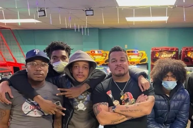 Aaron Campbell (second from right) poses with Level Up members in the group's arcade. From left are Nook Doe, 24; Cameron Rembert, 18; Aamere Casey, 19; and D'Angelo Gee, 19.