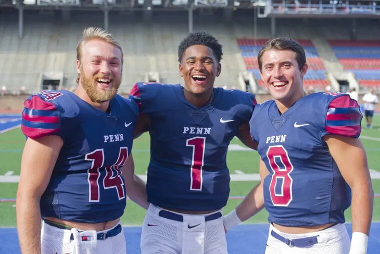 Quarterbacks (from left) Will Fischer-Colbrie, Ryan Glover, and Nick Robinson pose for photos during Penn Football Media Day at Franklin Field in West Philadelphia.