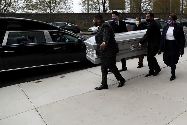 Staff from the Terry Funeral Home carry a casket to the hearse for a burial on April 16, 2020 in Philadelphia, Pa. The staff has taken on the role as pallbearers since the coronavirus outbreak because of social distancing measures. Pictured from left to right are Isiah Banks, Albert Aponte, Paula Wilder, Herb Baker, and Fateemah Jones.