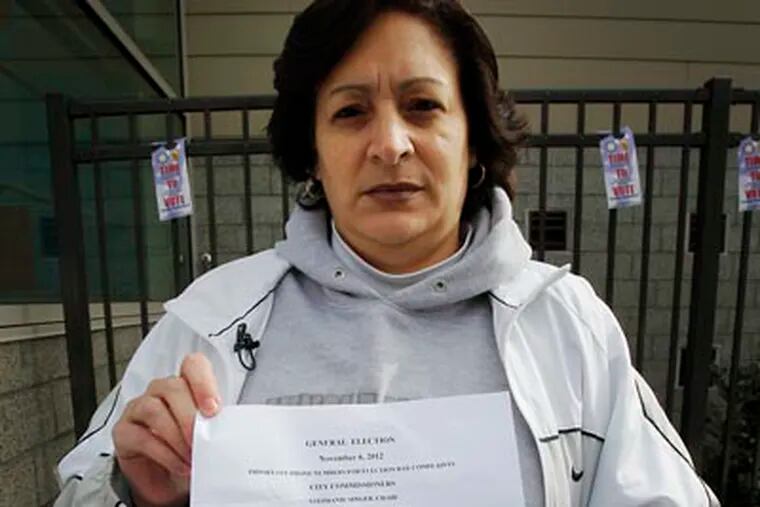 Mayra Acevedo of the Hunting Park section of Philadelphia holds up a sheet of paper containing numbers that according to poll workers are help for her and her situation. According to Mayra she registered to vote before the deadline but was not on the list. She was not given or offered a provisional ballot. Picture taken outside the Esperanza Health Center at 6th and Cayuga. This is the 43rd Ward, 3 and 6 district. Photo taken on Tuesday, November 6, 2012. (Alejandro A. Alvarez/Staff)