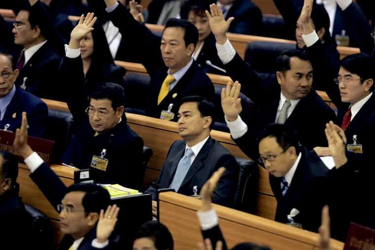 Surrounded by supporters, Abhisit Vejjajiva listens during proceedings in the Thai parliament in Bangkok. The vote was called after Somchai Wongsawat was ousted from office 10 days ago.