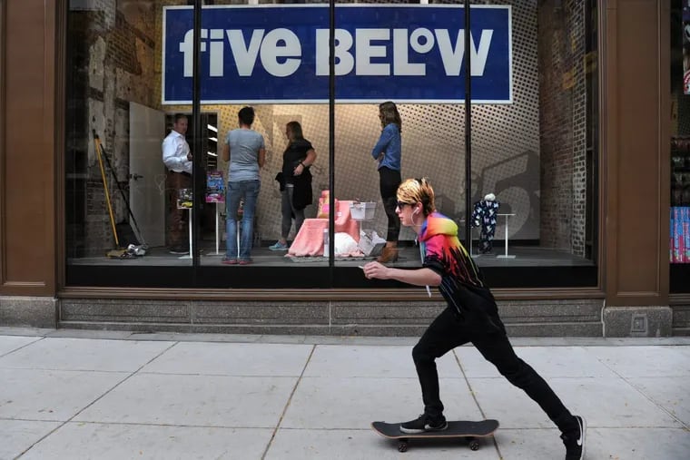 FILE photo shows Joel Anderson (left), CEO of Philadelphia-based Five Below, talking to employees in the historic Lit Brothers building on East Market Street. The trendy retailer expects to have esports gaming centers in some of its stores by mid 2020.