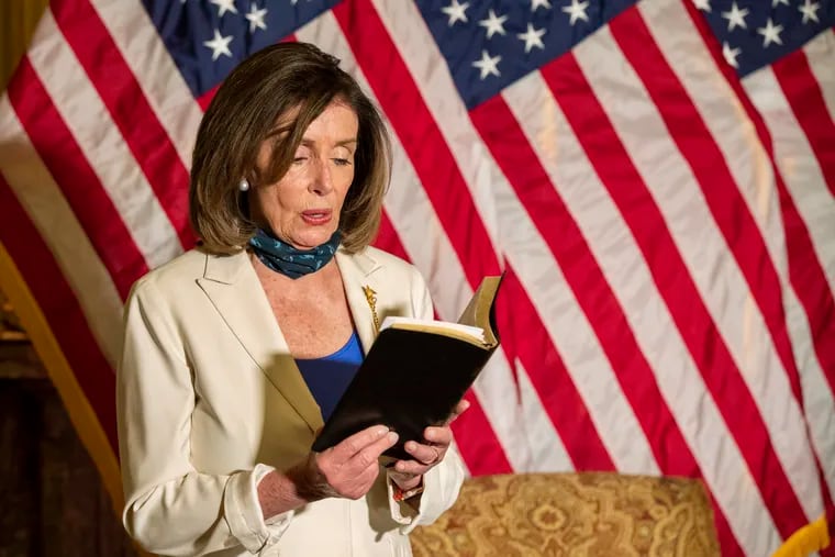 House Speaker Nancy Pelosi of Calif., reads from the Bible, as she reacts to President Donald Trump during a news conference at the U.S. Capitol in Washington on Tuesday.