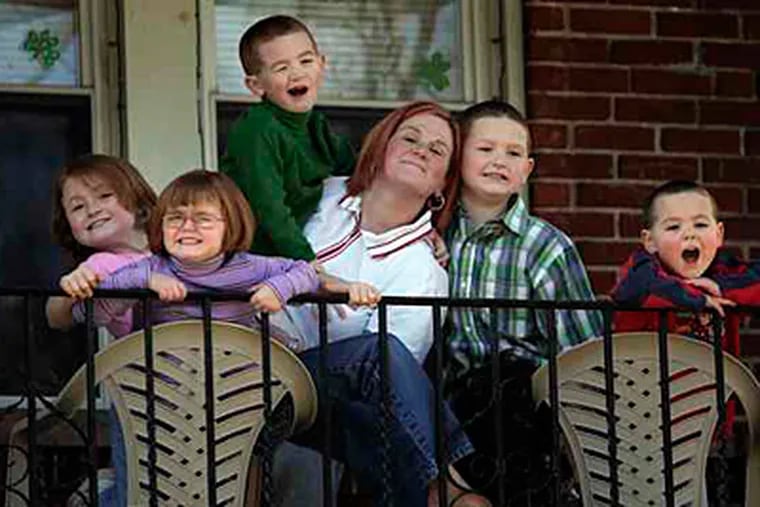 Lisa Mathews with children (from left) Theresa, 7, Cheyanne, 5, Shawn, 6, Tyler, 8, and Anthony, 4, at their home in Northeast Philadelphia. Three of the children have ADHD or autism disorders.