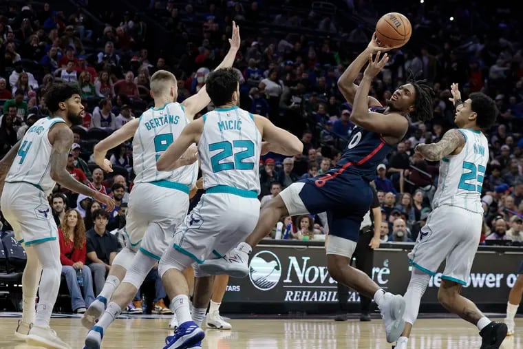 Sixers' Tyrese Maxey shoots after being fouled against the Charlotte Hornets on Saturday.