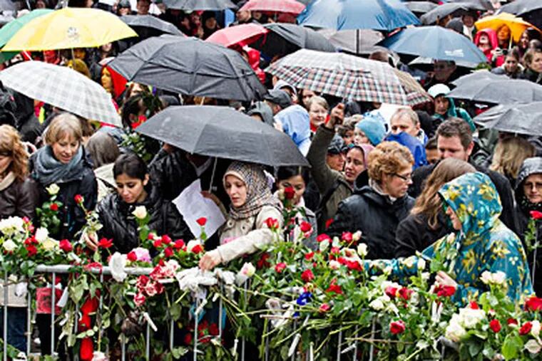 Outside the courthouse where Anders Behring Breivik is on trial, demonstrators who gathered for a sing-along place flowers at the gate. The song they chose is one the confessed mass killer contends brainwashes youth. HEIKO JUNGE / AP, NTB scanpix