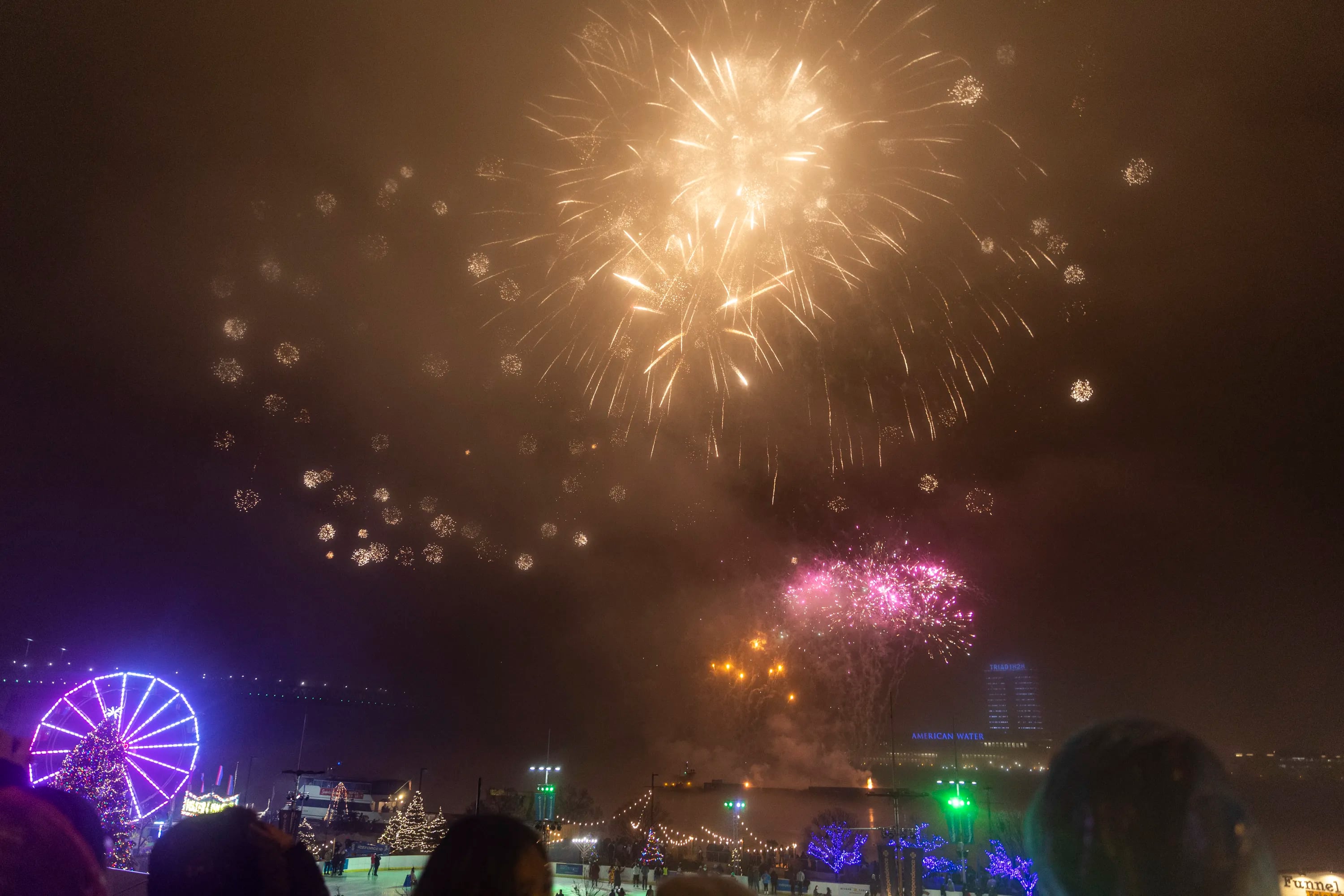 People watch the Rivers Casino New Year’s Eve fireworks show on the Waterfront in Philadelphia, Pa., on Saturday, Dec. 31, 2022.