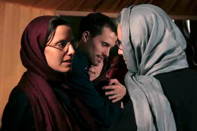 Sarah Shourd talks to her mother, Nora Shourd, as Shane Bauer hugs his mother, Cindy Hickey, at the Esteghlal Hotel in Tehran, Iran. The mothers of three Americans jailed in Iran for 10 months spent time with their children for a second day Friday.