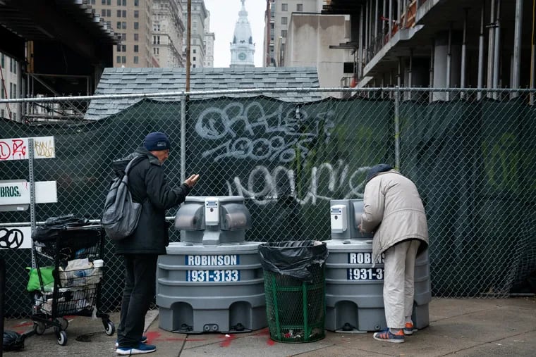 Two men use a portable outdoor hand washing station outside Broad Street Ministries, in Philadelphia, March 19, 2020. Both men are guests at Broad Street Ministries which has indoor hand washing and hand sanitizing stations inside in addition to this outdoor unit in front of the church. The coronavirus has been spreading across the globe since January, and now has been identified in the Philadelphia region, all non-essential businesses are closed. Cities around the United States, including Philadelphia, are increasing social restrictions and implementing cleaning strategies in an attempt to slow the virus’ spread.