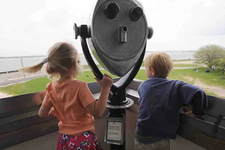 Caroline Sher , 4, and Tommy Armstrong, 3, of Longport check out the view from the top of the Atlantic City Aquarium/Ocean Life Center, one of the attractions at Historic Gardner's Basin. (April Saul / Staff Photographer)