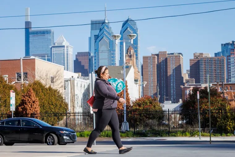 A woman carries bottled water. The city's website has translated some updates into Spanish, but speakers of other languages have had to rely on shared information.