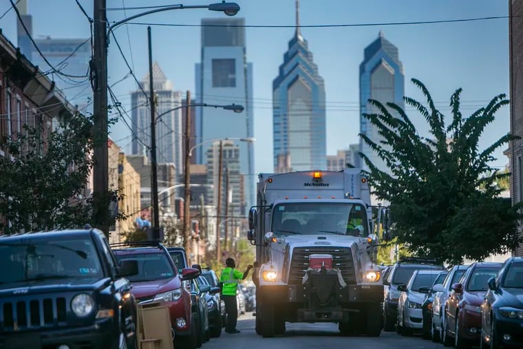 Sanitation works make their way south on 17th Street in Point Breeze on Tuesday.