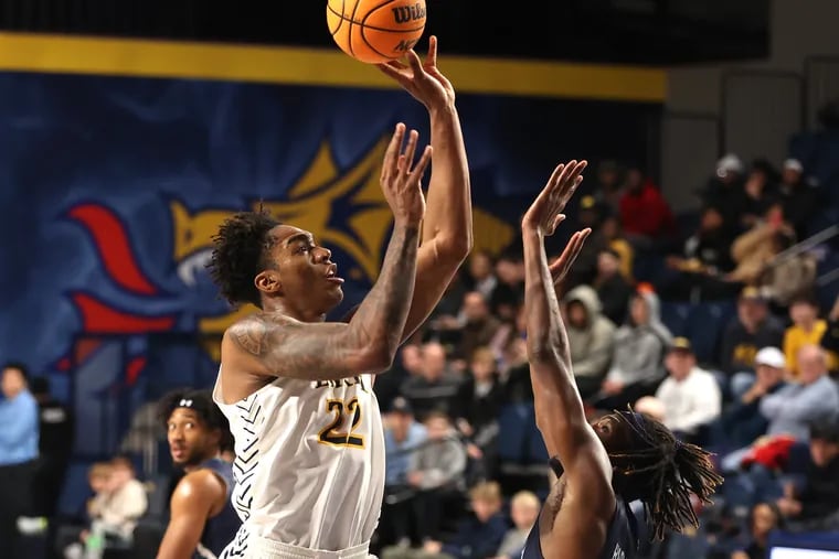 Amari WIlliams (left) of Drexel shoots over Maleeck Harden-Hayes of UNC Wilmington during the first half on Jan. 4, 2024.