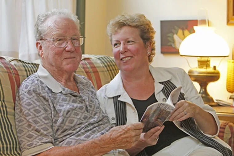 Charlie Sherf and daughter Barbara hold a copy of "Cowboy Mission: The Best Sermons Are Lived … Not Preached," the book they co-wrote about his remembrances. (Akira Suwa / Staff Photographer)
