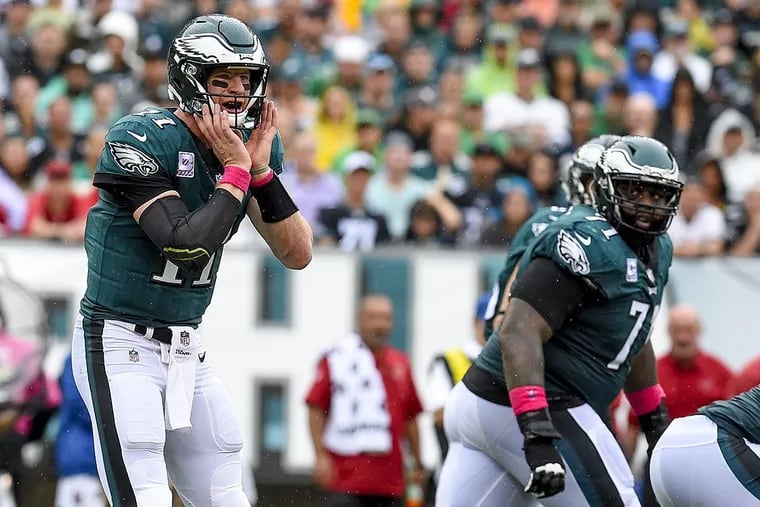 Eagles all-pro tackle Jason Peters looks back at Eagles quarterback Carson Wentz as he makes an audible in the game against the Arizona Cardinals.