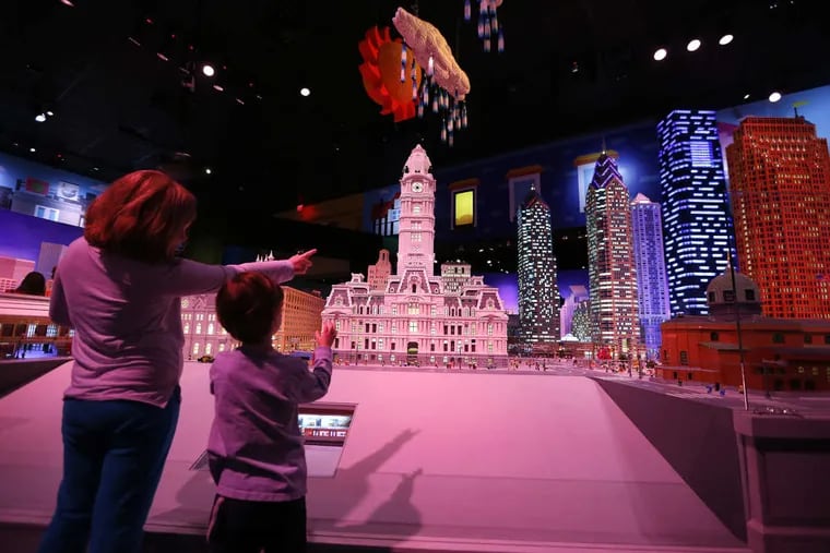 Jenna Harvey, left, 9, and her brother, Billy Harvey, 4, of Pennsburg, PA, look at a Lego rendition of downtown Philadelphia during the grand opening of Legoland Discovery Center in the Plymouth Meeting Mall in Plymouth Meeting, PA on March 31, 2017.