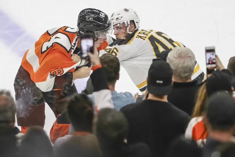 Flyers rookie center Nolan Patrick fights with Bruins center David Krejci during the second period on Thursday.